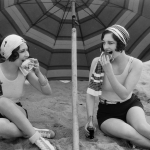 women under beach umbrella